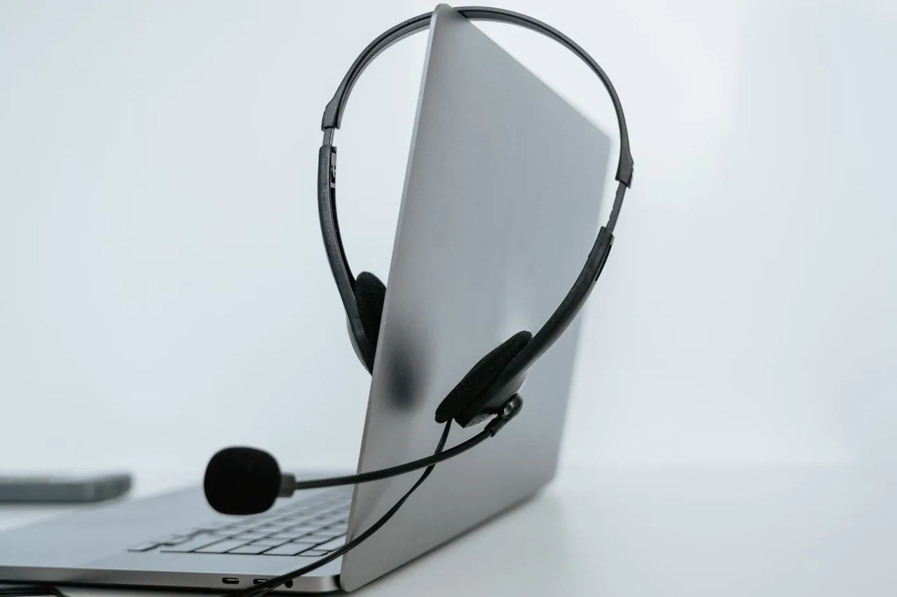 A headset resting on a laptop, ready to take your call